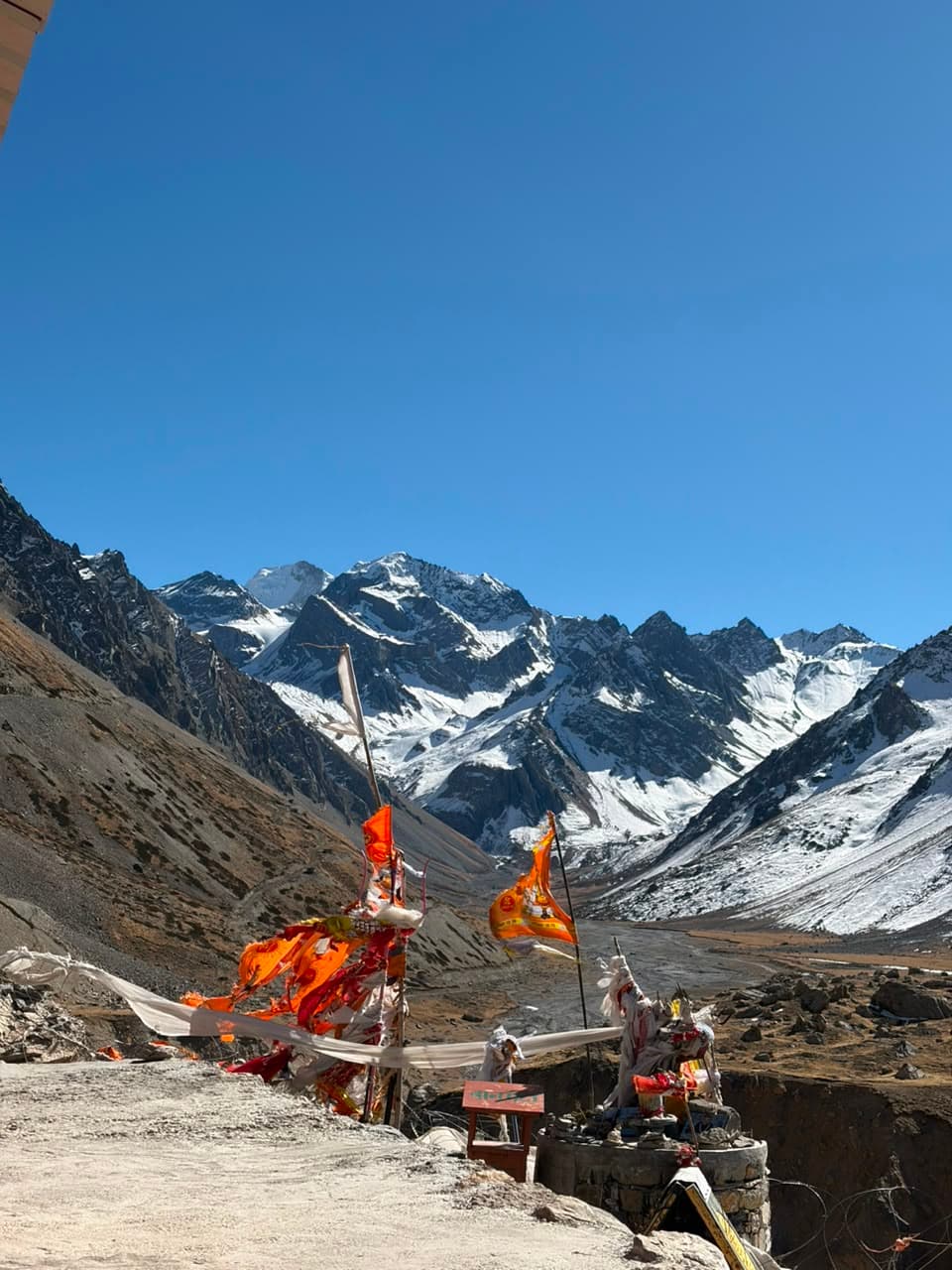 Prayer flags at the Adi Kailash shrine with the peak behind