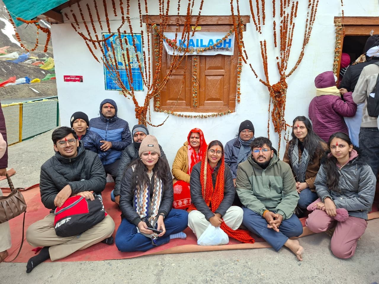 Devotees seated for darshan at the Kailash shrine